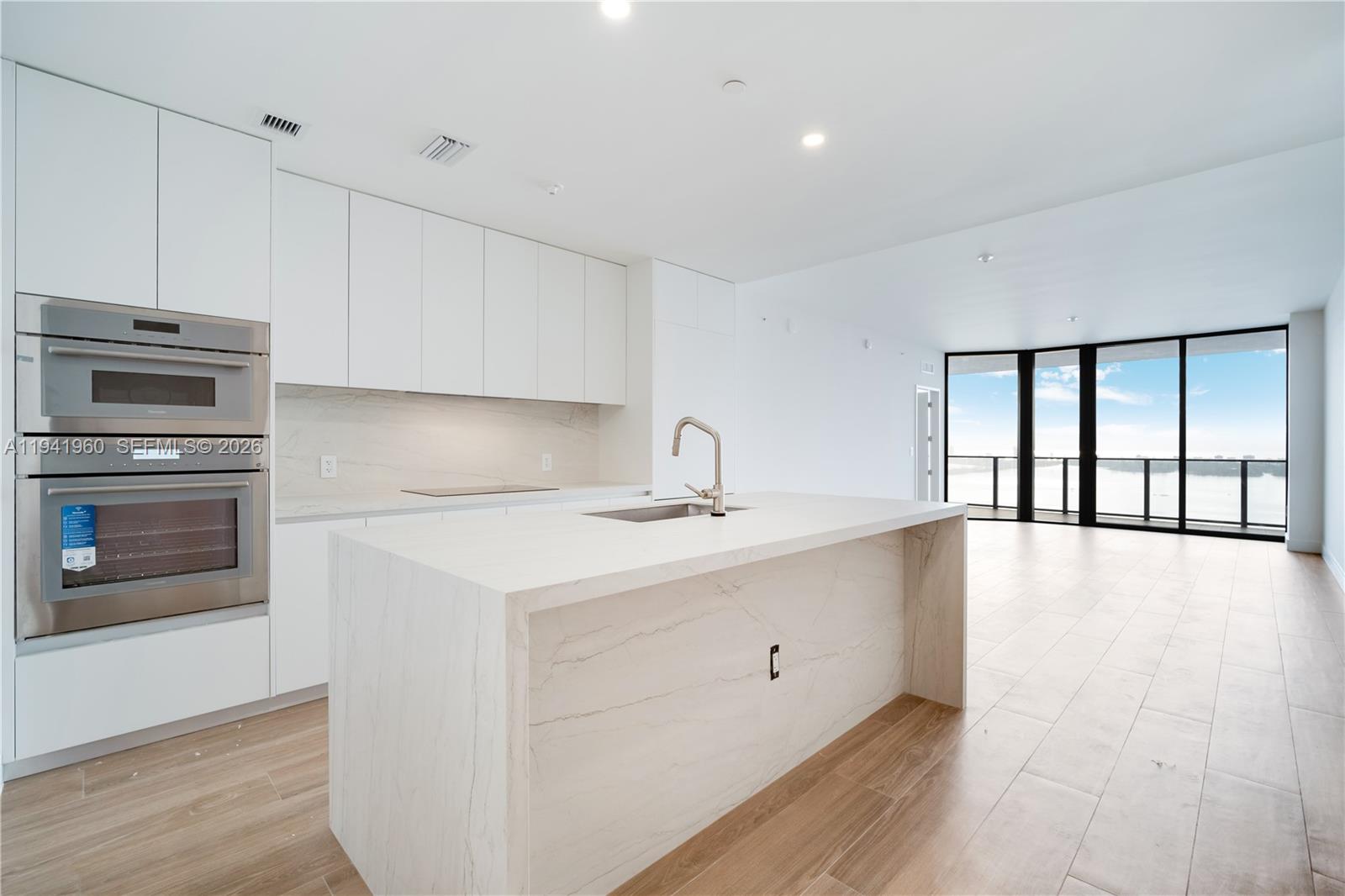 700 Northeast 24th Street, Unit 4203 Miami, FL 33137 - Photo 5 of 51 a kitchen with a sink cabinets and stainless steel appliances