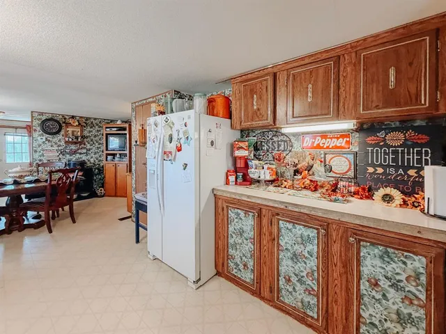 a kitchen with stainless steel appliances granite countertop a refrigerator and car
