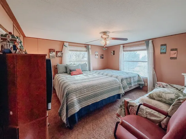 a bedroom with bed and window