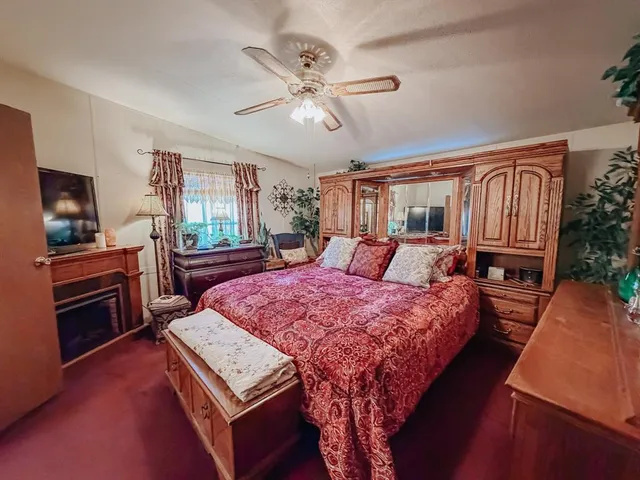 a bed room with a bed window and a television