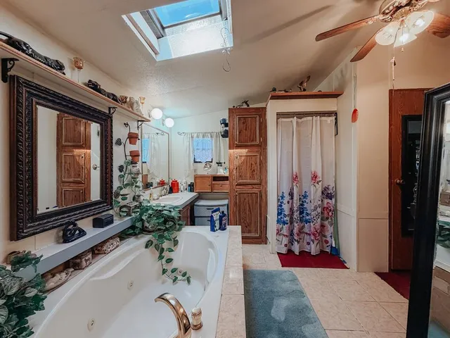 a living room with furniture a flat screen tv and a floor to ceiling window