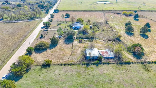a aerial view of a house with a yard and lake view