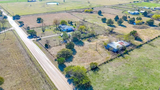 an aerial view of house with a yard
