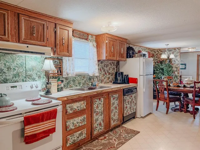 a kitchen with stainless steel appliances granite countertop a sink and cabinets