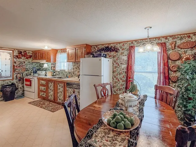 a room with furniture a chandelier and a window