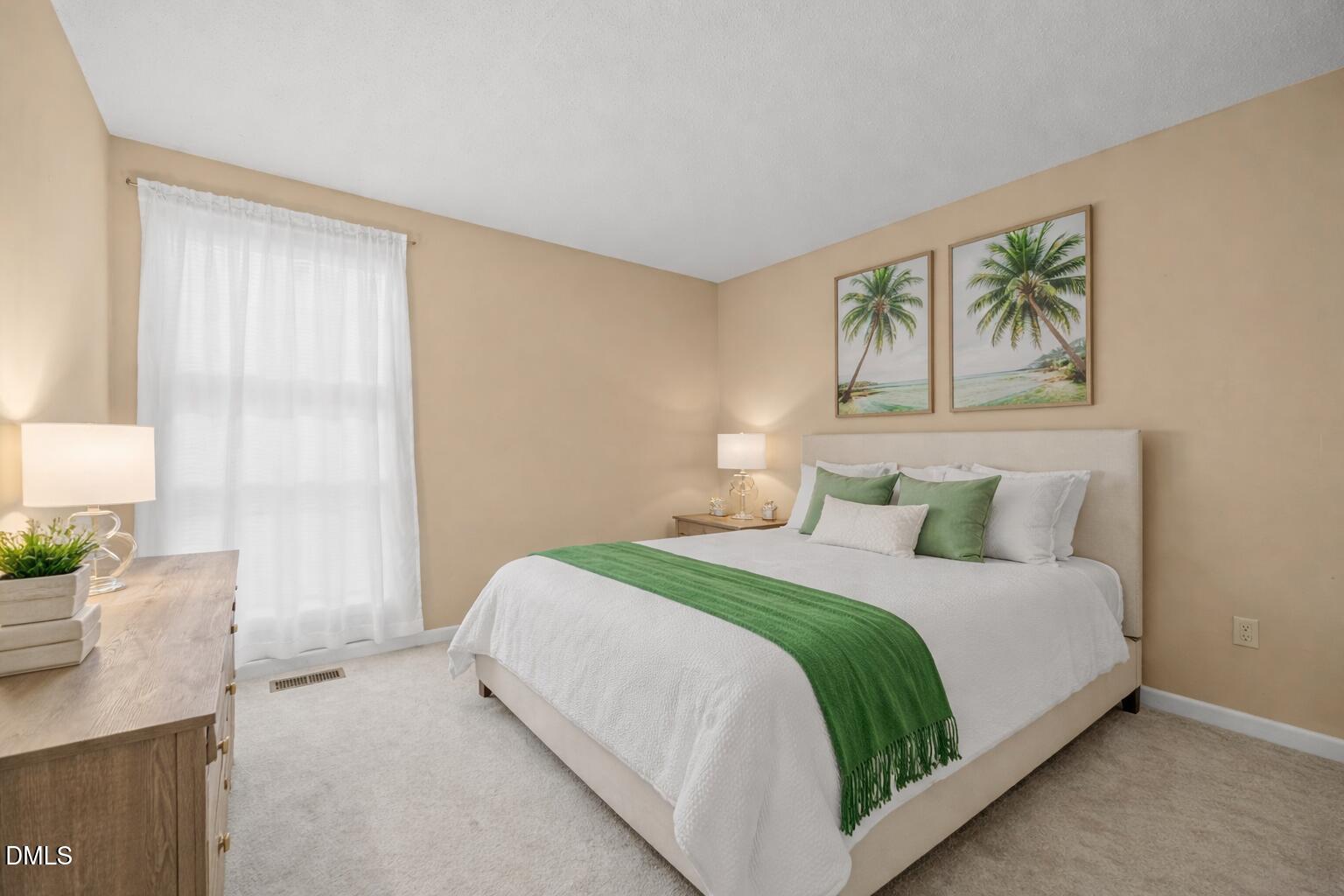 5816 Pointer Drive, Unit 102 Raleigh, NC 27609 - Photo 18 of 25 a bedroom with a bed and a painting on the wall