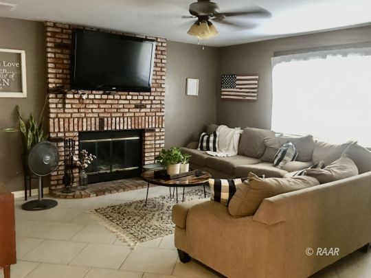 509 South Appaloosa Street Ridgecrest, CA 93555 - Photo 4 of 26 a living room with furniture a flat screen tv and a fireplace