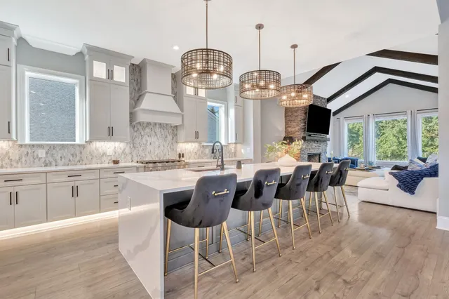 a view of a dining room with furniture wooden floor and a chandelier