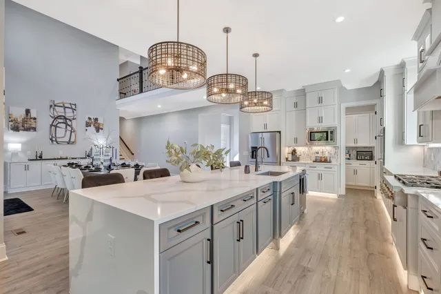 a living room with lots of furniture and a wooden floor