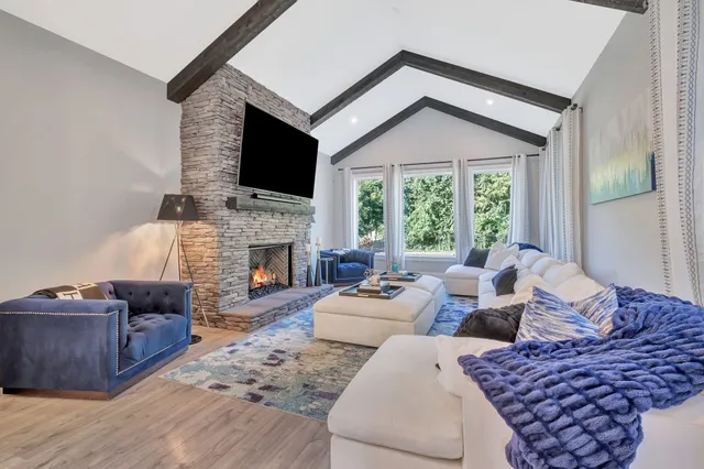 a view of a living room a flat screen tv and a kitchen