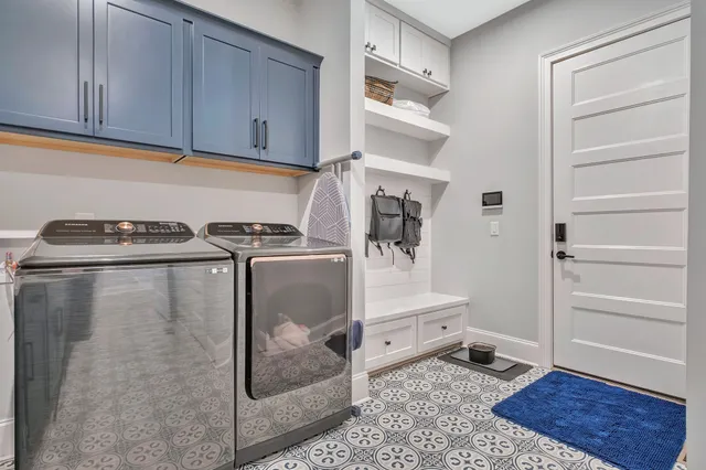 a living room with a couches and kitchen view