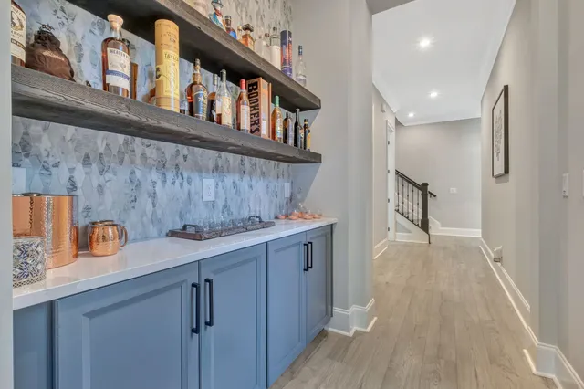a living room with furniture floor to ceiling window and a flat screen tv