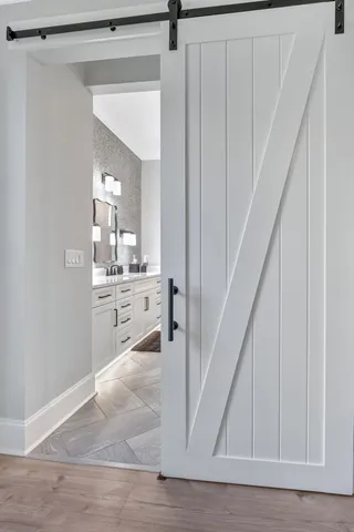 a spacious bedroom with a bed and a chandelier