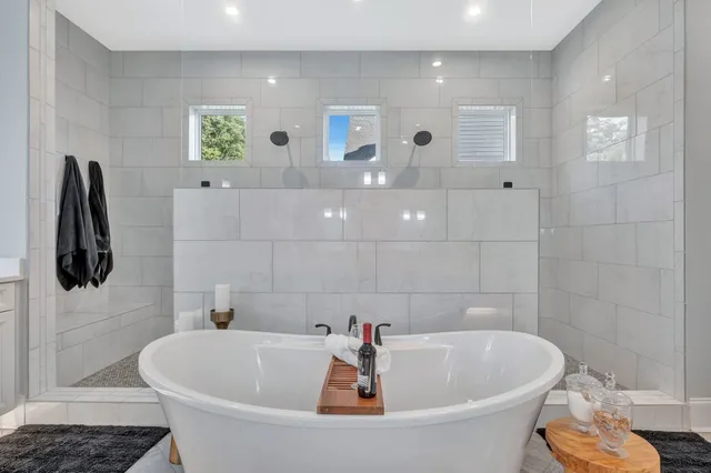 a spacious bedroom with a large bed and a chandelier