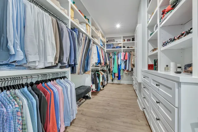 a dining room with furniture a rug and a floor to ceiling window