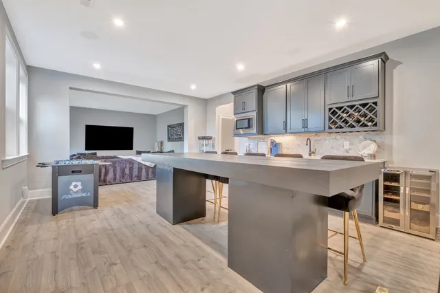 a view of a patio with table and chairs with wooden floor and fence
