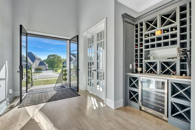 a dining room with furniture window and wooden floor
