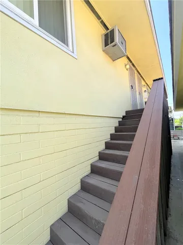 a view of staircase with wooden floor and white walls