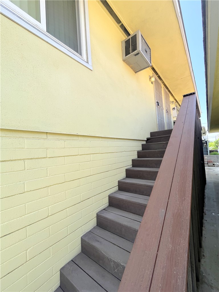 12 West Cypress Avenue Redlands, CA 92373 - Photo 2 of 10 a view of staircase with wooden floor and white walls