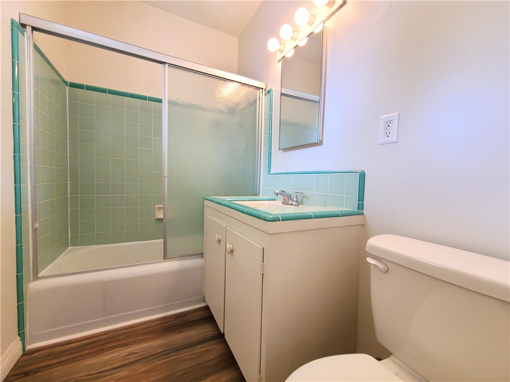 12 West Cypress Avenue Redlands, CA 92373 - Photo 9 of 10 a bathroom with a granite countertop sink toilet and shower