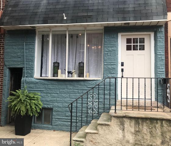 a view of a brick house with plants