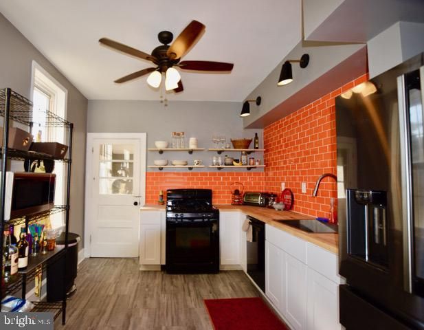 a kitchen with stainless steel appliances granite countertop a refrigerator a stove top oven a sink and dishwasher
