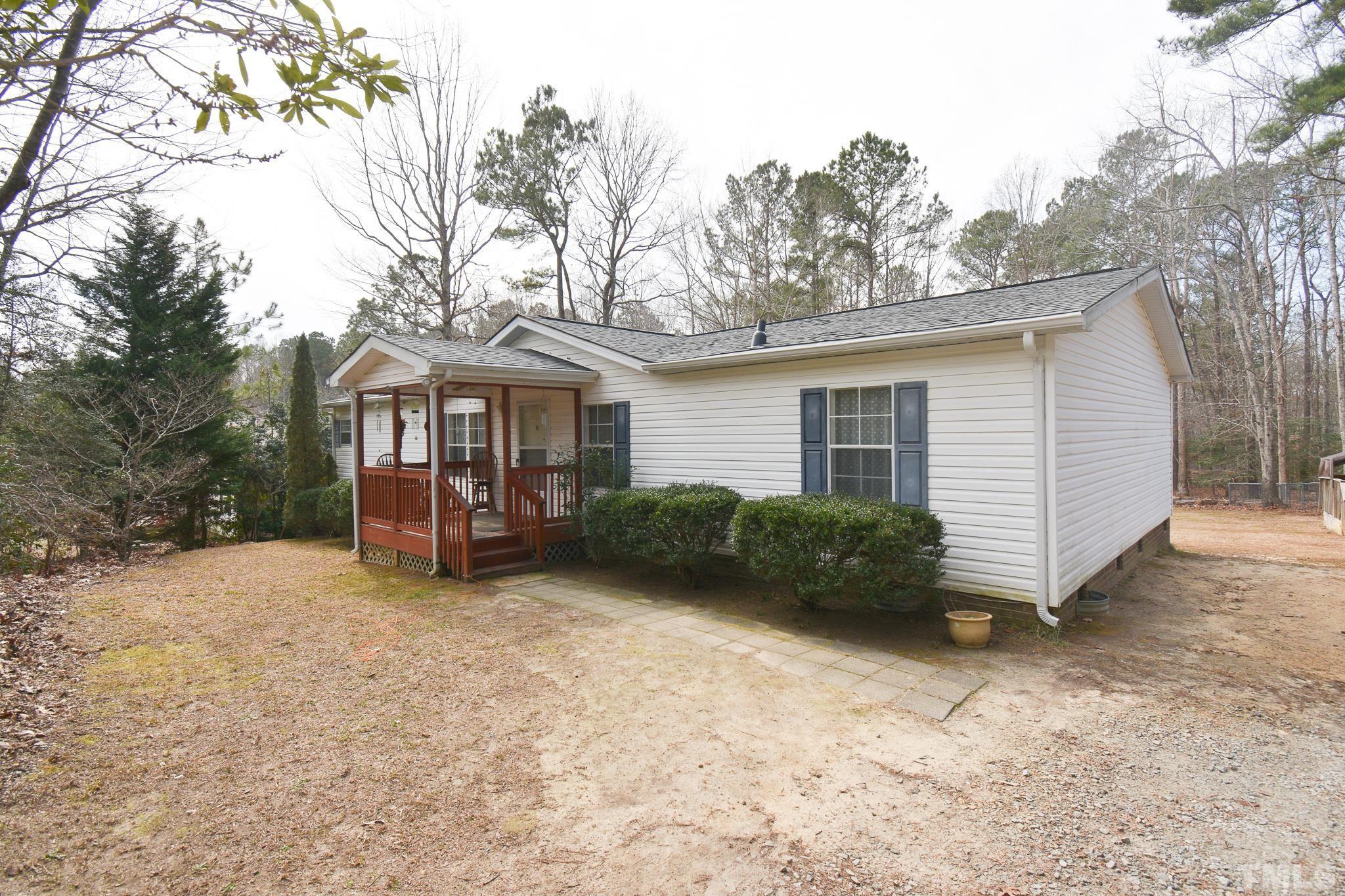 8484 South Creek Road Willow Spring, NC 27592 - Photo 1 of 33 a view of a house with a yard and roof
