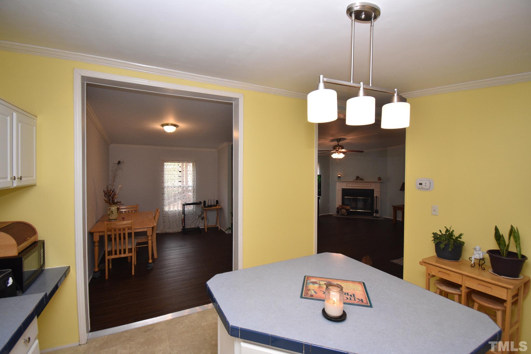 8484 South Creek Road Willow Spring, NC 27592 - Photo 13 of 33 a dining room with furniture and wooden floor