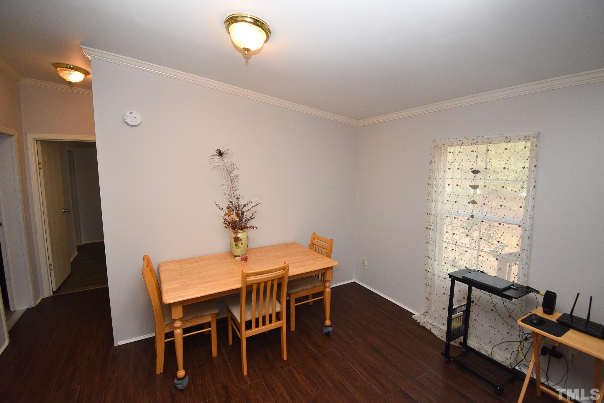 8484 South Creek Road Willow Spring, NC 27592 - Photo 15 of 33 a dining room with furniture and wooden floor