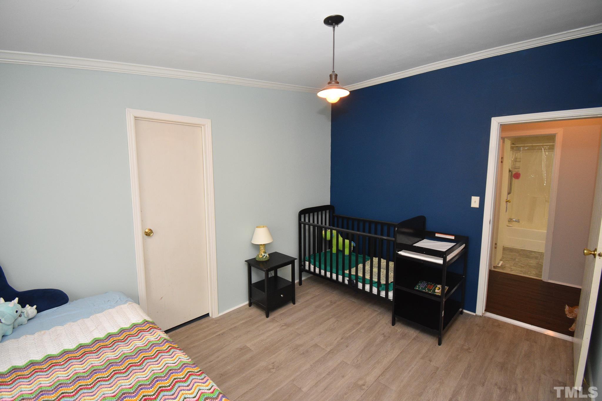 8484 South Creek Road Willow Spring, NC 27592 - Photo 17 of 33 a bedroom with furniture and a window