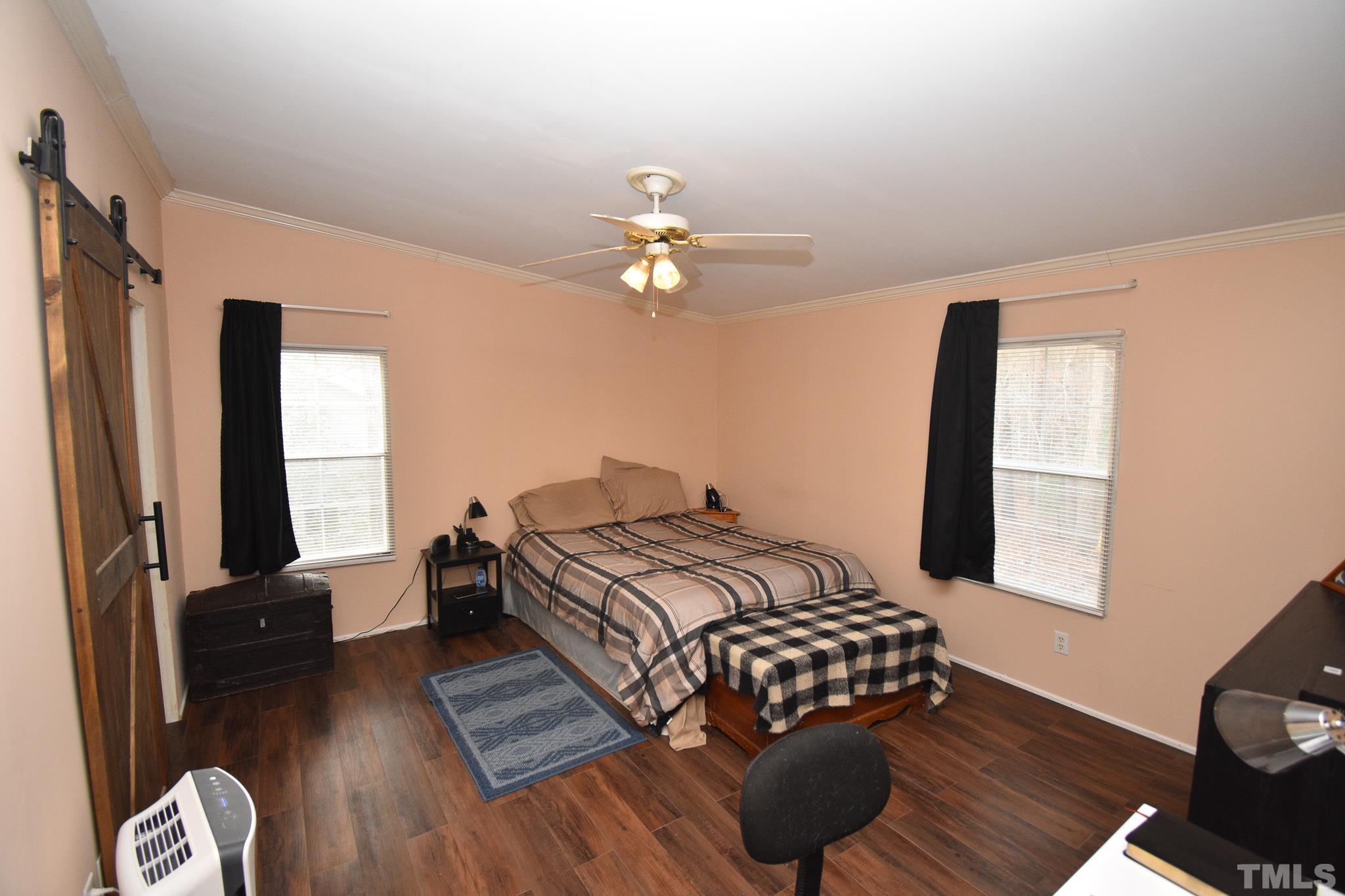 8484 South Creek Road Willow Spring, NC 27592 - Photo 21 of 33 a bedroom with a bed dresser and a window