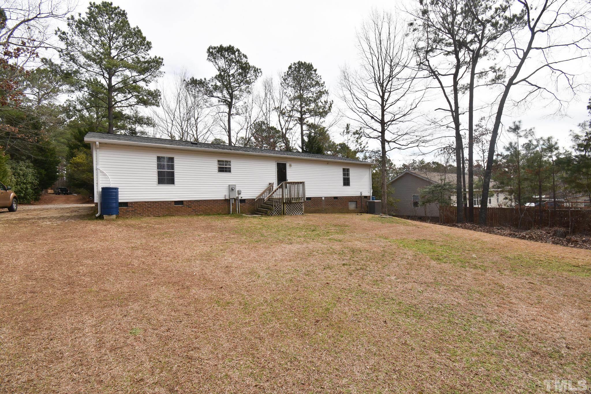 8484 South Creek Road Willow Spring, NC 27592 - Photo 28 of 33 a view of a house with a yard and garage