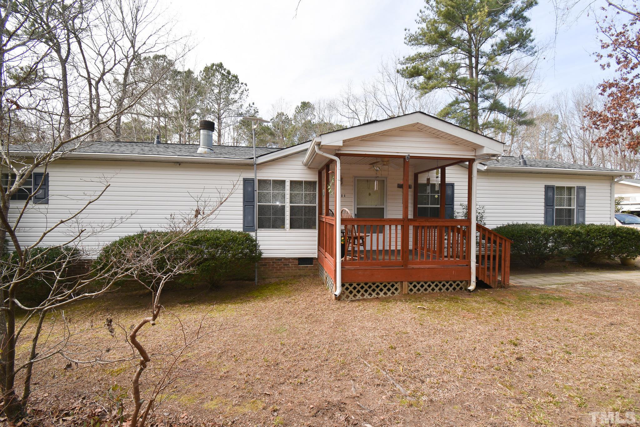 8484 South Creek Road Willow Spring, NC 27592 - Photo 3 of 33 a backyard of a house with barbeque oven and table