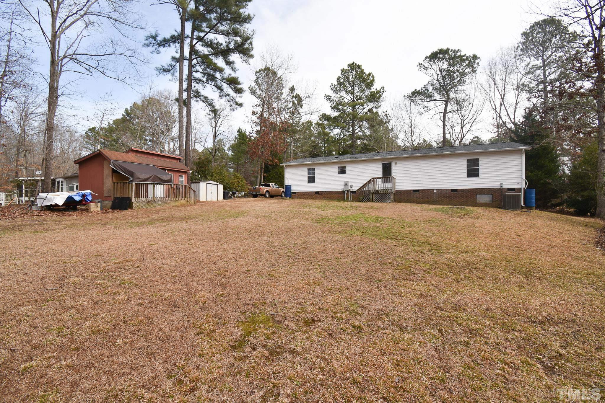 8484 South Creek Road Willow Spring, NC 27592 - Photo 33 of 33 a front view of a house with a yard and garage