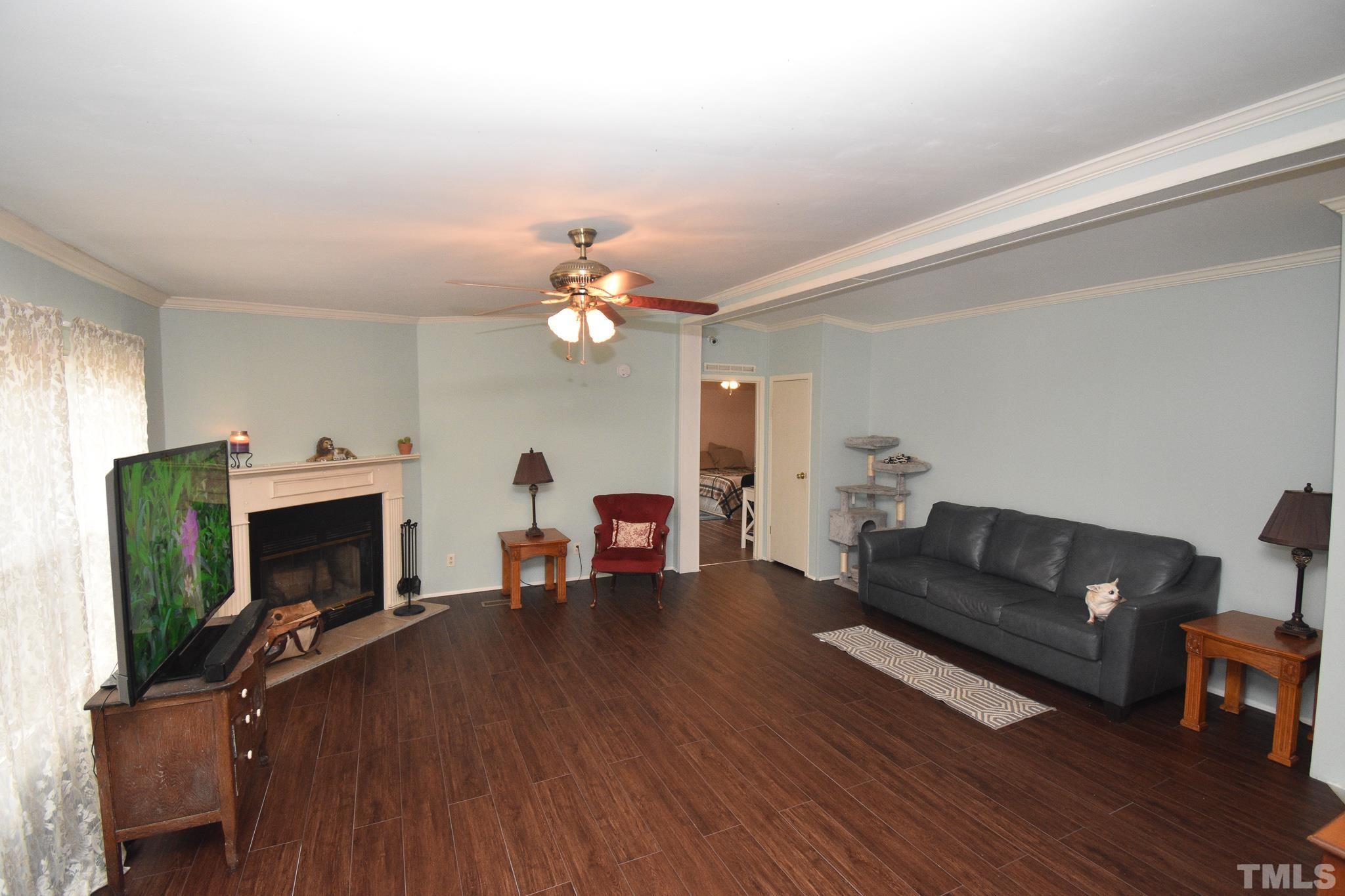 8484 South Creek Road Willow Spring, NC 27592 - Photo 5 of 33 a living room with furniture fireplace and flat screen tv