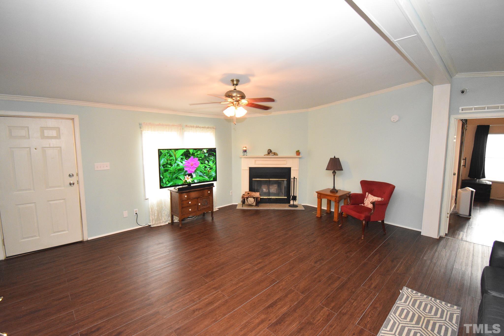 8484 South Creek Road Willow Spring, NC 27592 - Photo 7 of 33 a view of a livingroom with furniture and a fireplace