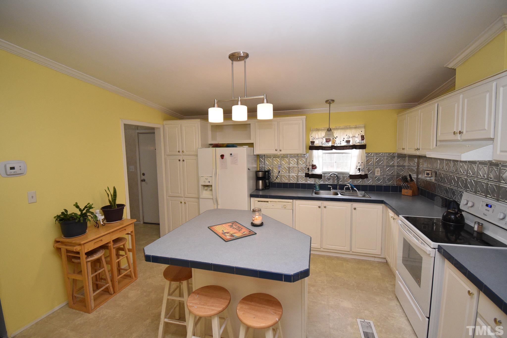 8484 South Creek Road Willow Spring, NC 27592 - Photo 8 of 33 a kitchen with a sink cabinets and window