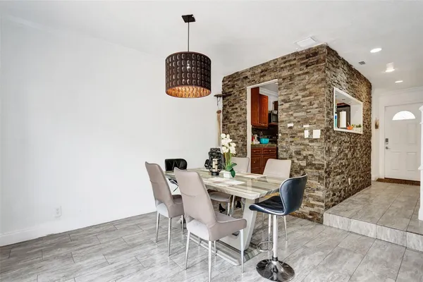 a view of a dining room with furniture and chandelier