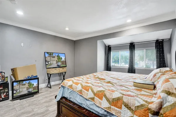 a bedroom with a bed and a painting on the wall