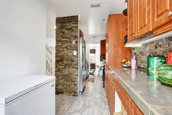 a view of a kitchen with furniture and wooden floor