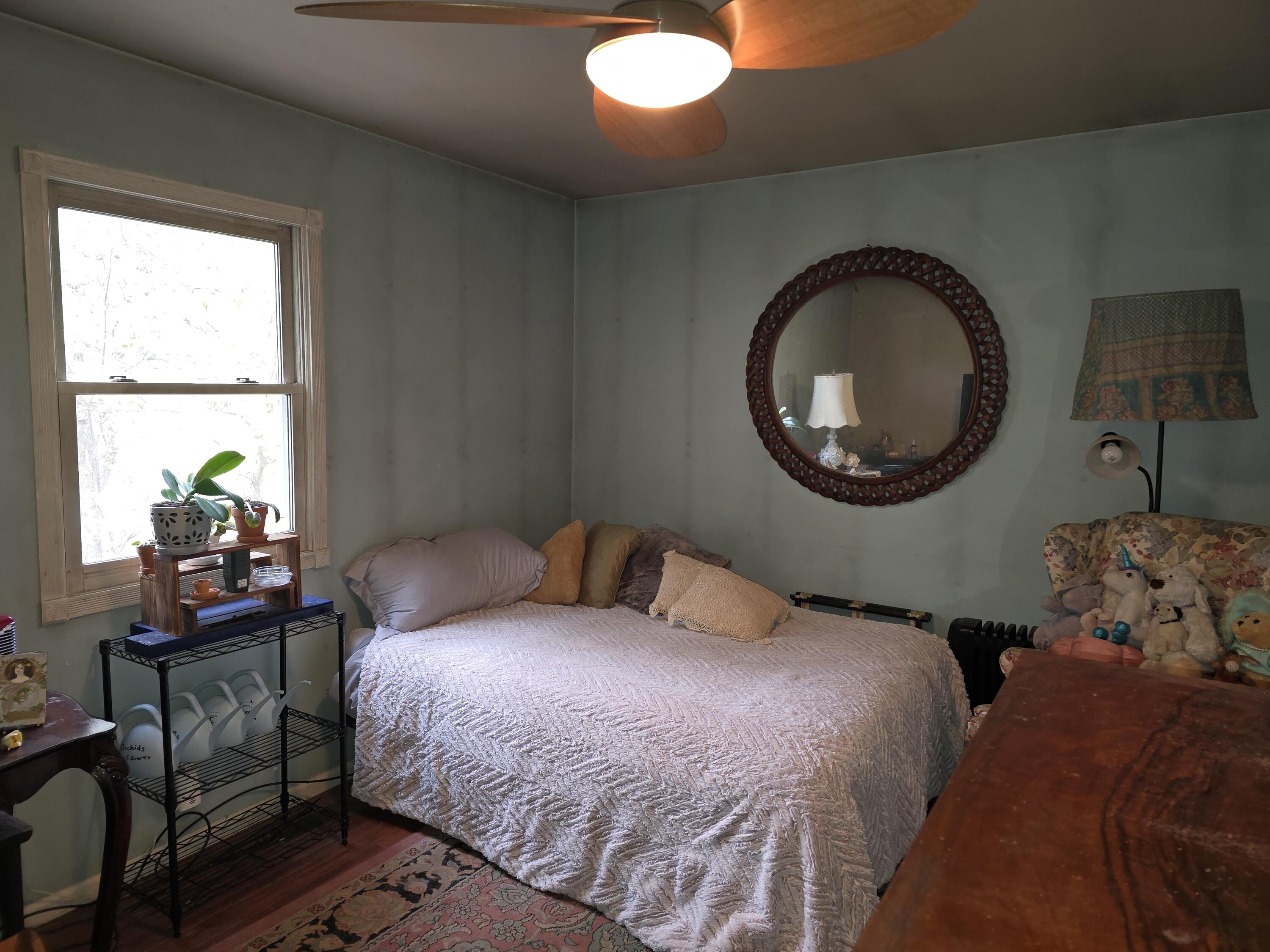 218 Chickadee Trail Michigan City, IN 46360 - Photo 23 of 40 a bedroom with a bed and a large mirror next to a window