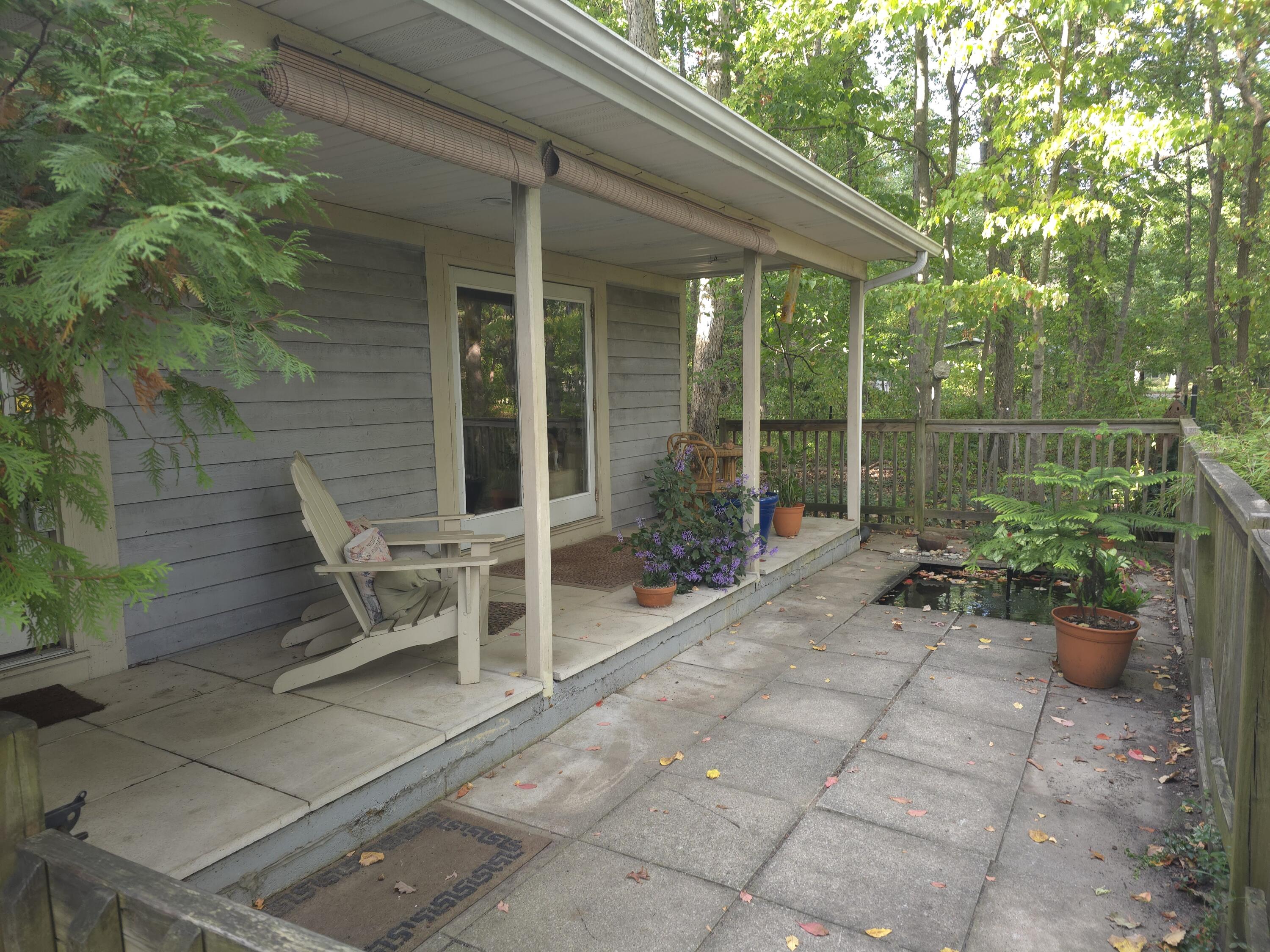 218 Chickadee Trail Michigan City, IN 46360 - Photo 9 of 40 a view of a chair and tables in the patio