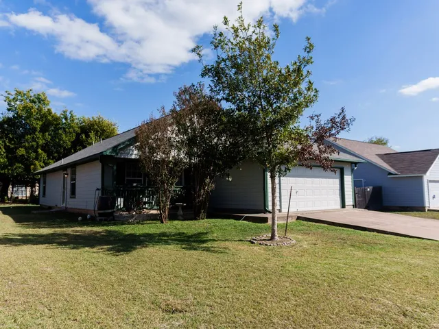 a front view of house with yard and trees