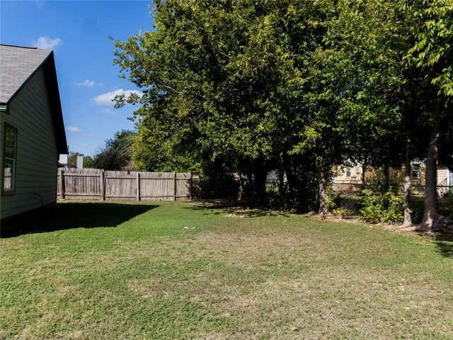 a view of a tree in front of a house