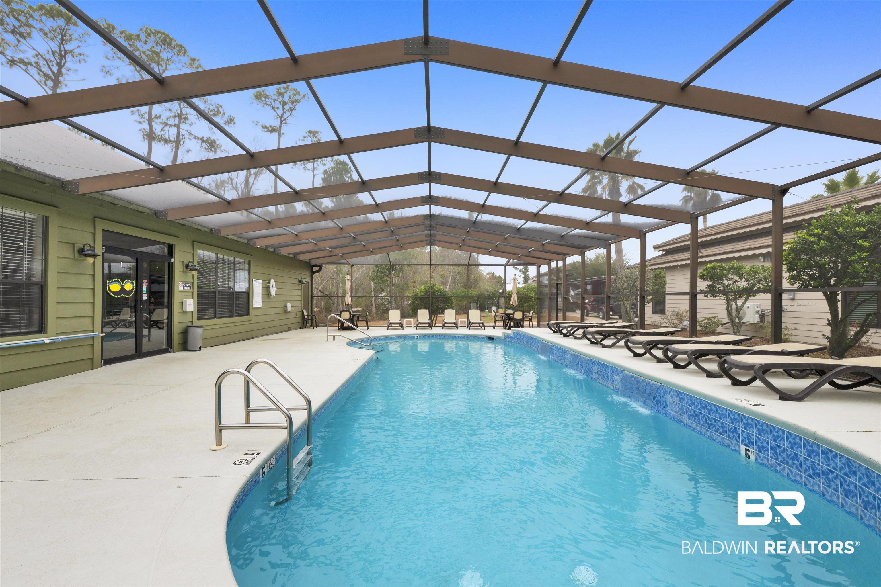 4650 Griffith Marina Road, Unit LOT 24 Orange Beach, AL 36561 - Photo 24 of 34 Community pool with a lanai, a patio area, a sunroom, and french doors