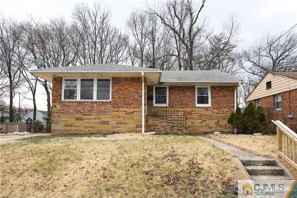 10 Gurley Road Edison, NJ 08817 - Photo 2 of 17 a front view of a house with a yard covered in snow