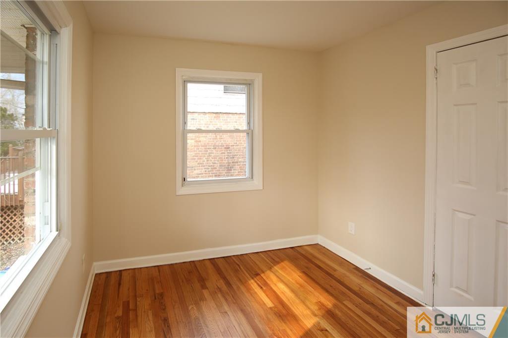 10 Gurley Road Edison, NJ 08817 - Photo 12 of 17 an empty room with wooden floor and windows