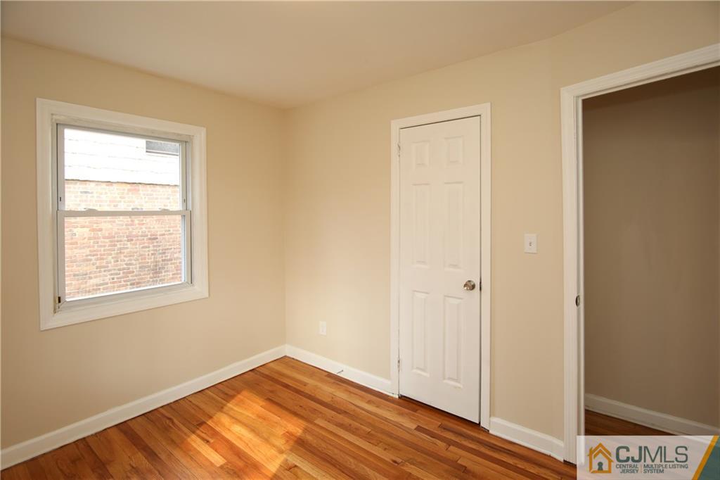 10 Gurley Road Edison, NJ 08817 - Photo 13 of 17 a view of an empty room with wooden floor and a window