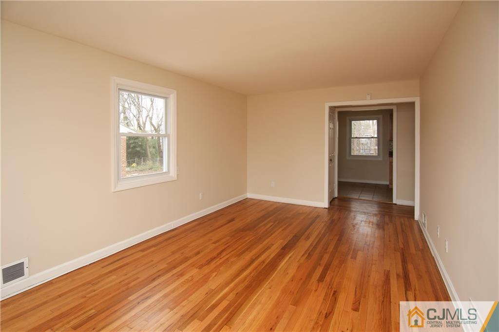 10 Gurley Road Edison, NJ 08817 - Photo 4 of 17 a view of an empty room with wooden floor and a window