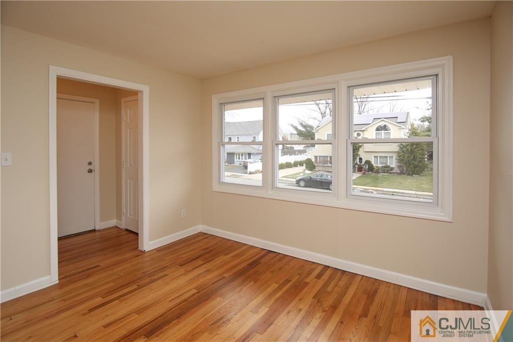 10 Gurley Road Edison, NJ 08817 - Photo 5 of 17 a view of an empty room with wooden floor and a window